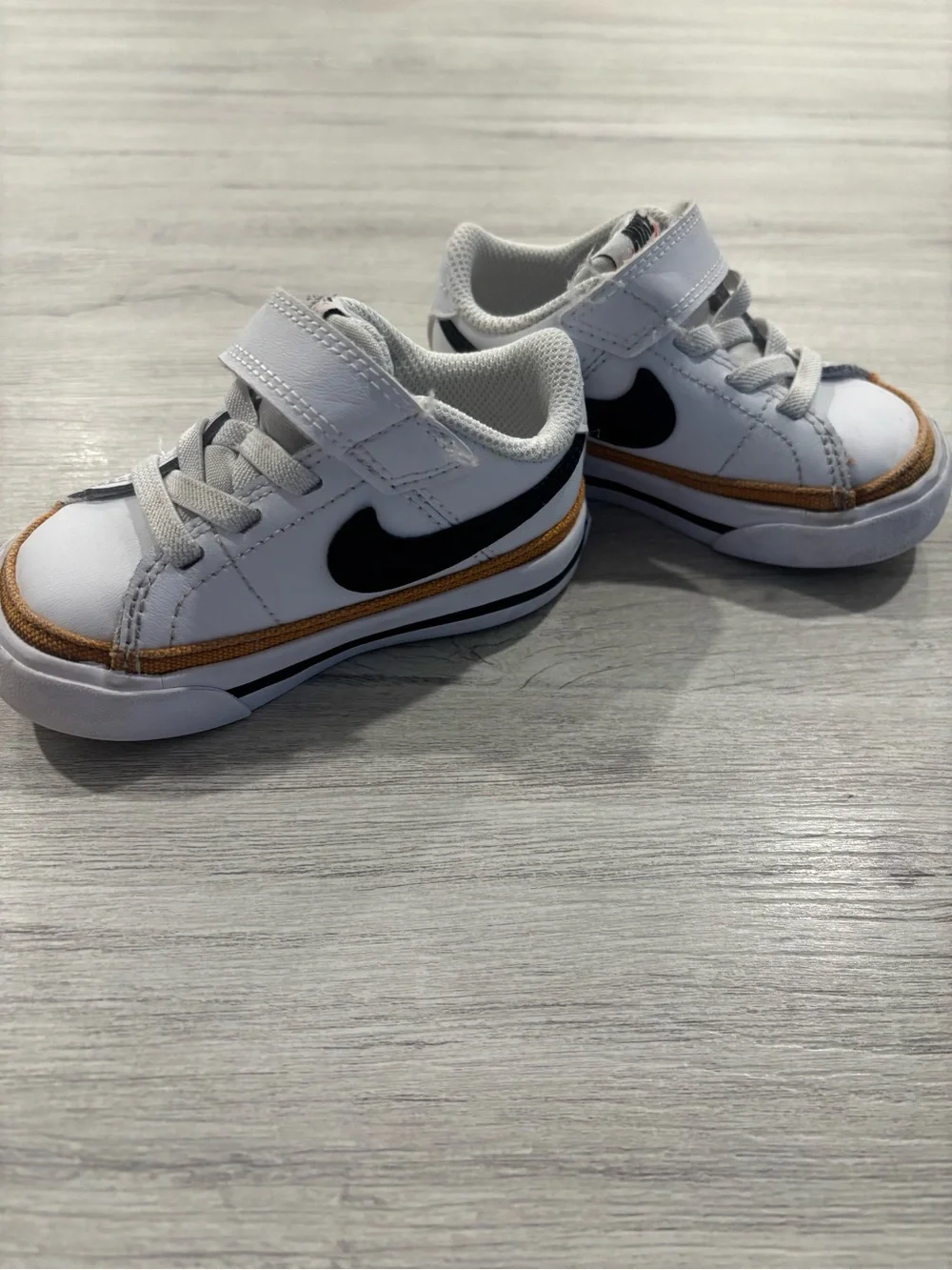Nike Kids White Sneakers with Black Swoosh and Brown Trim